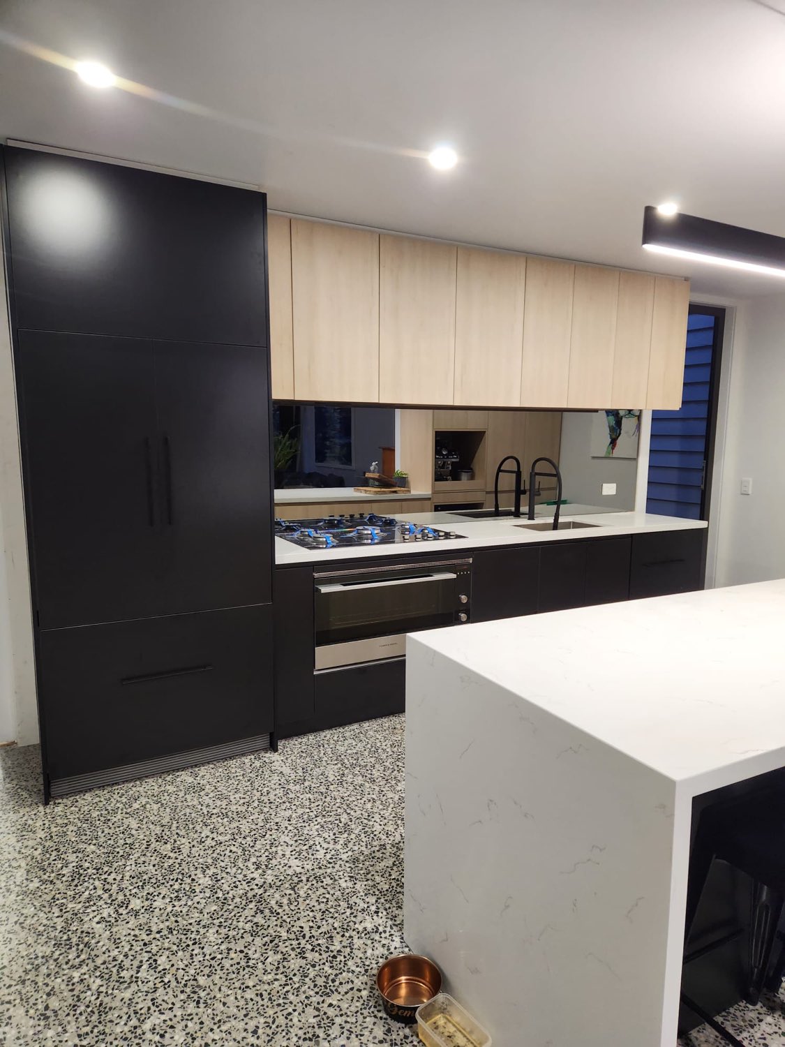 Black and oak kitchen with waterfall island