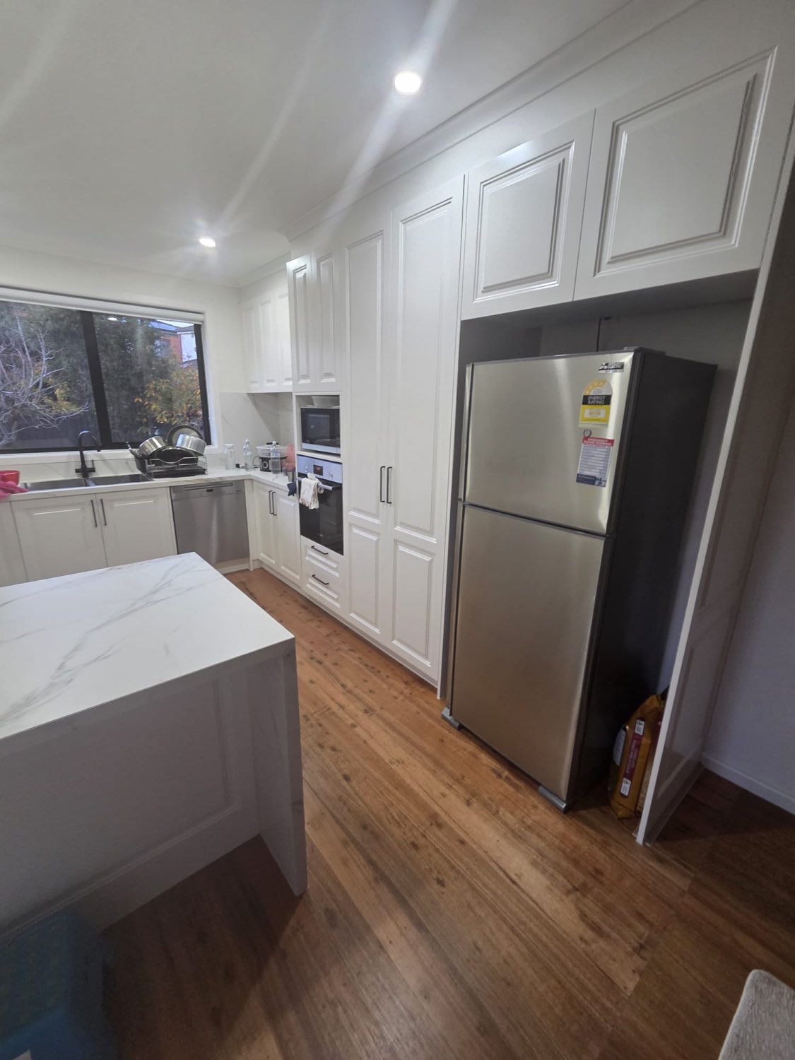 White shaker kitchen with full-height pantry
