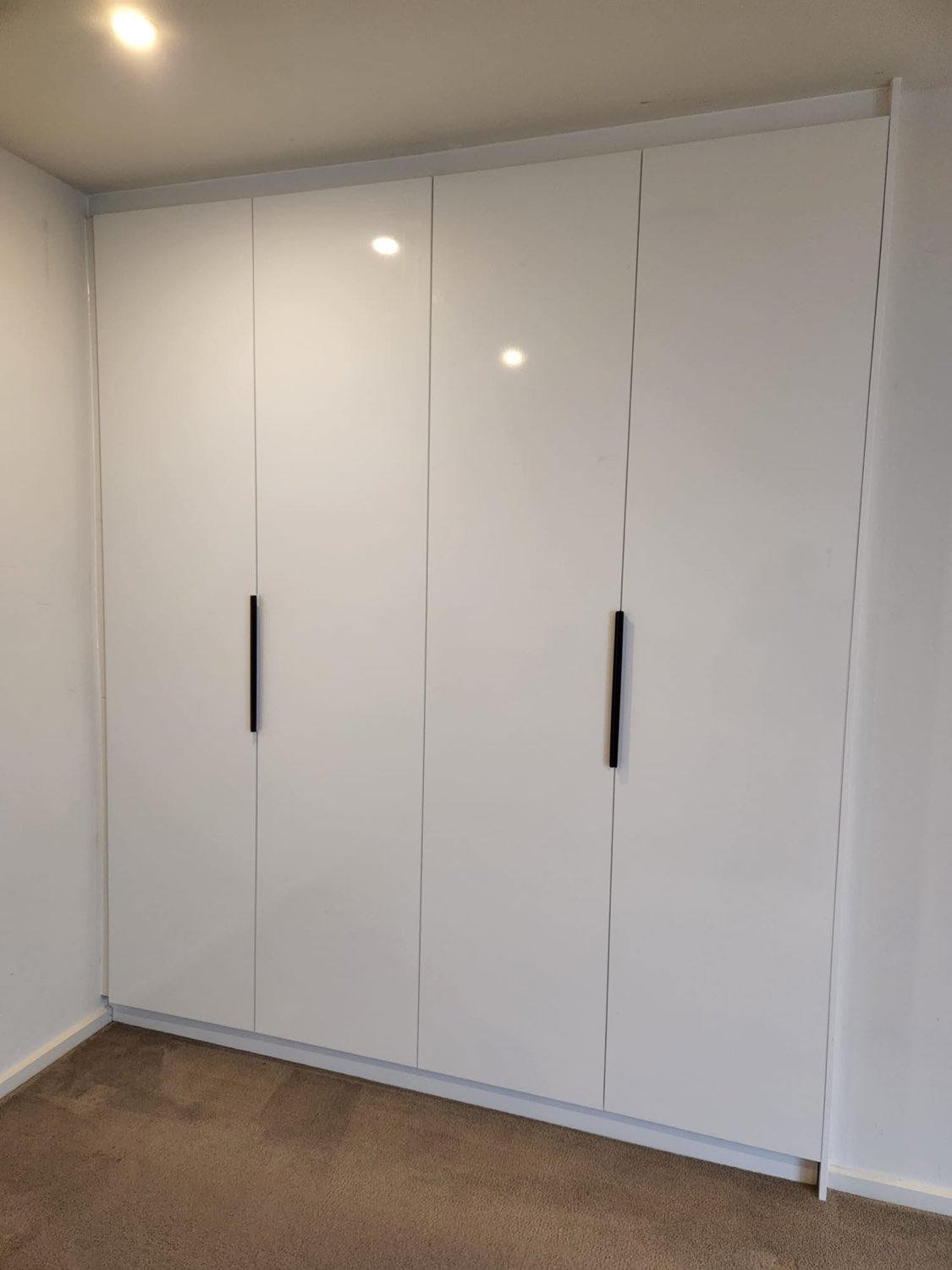 White gloss four-door built-in wardrobe